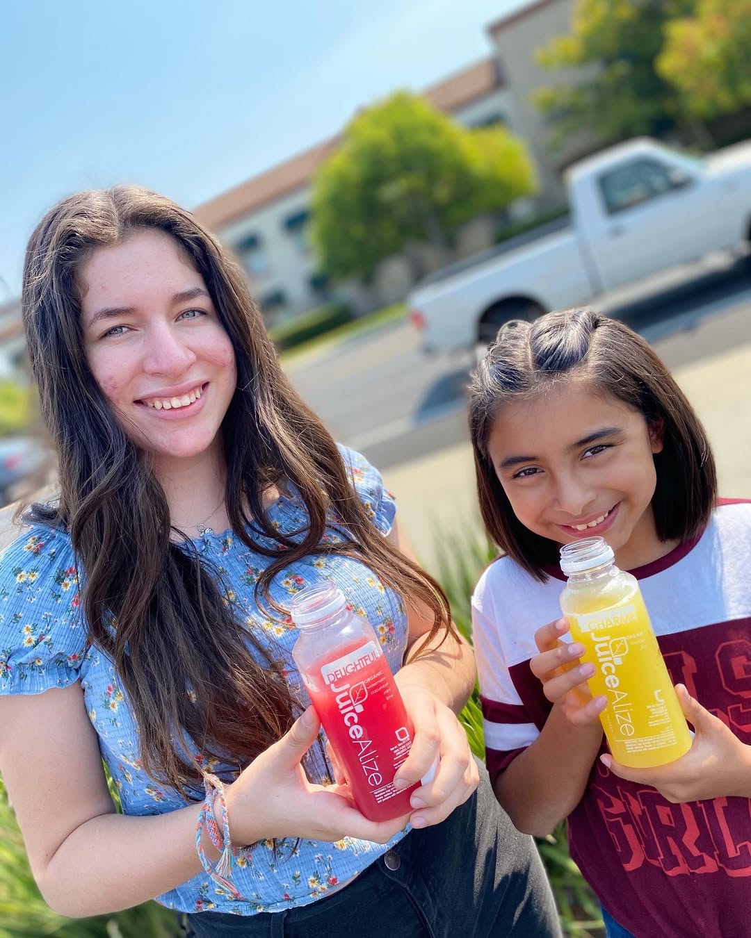 Two girls with DELIGHTFUL watermelon and CHARMED pineapple juices