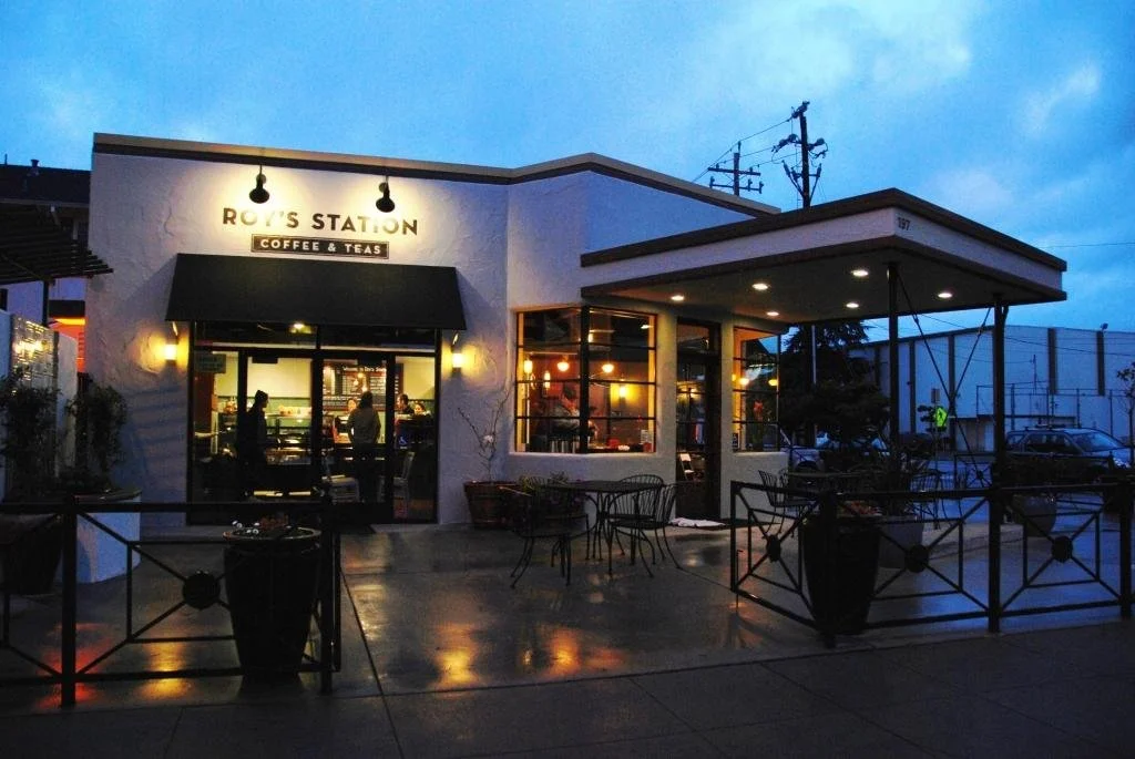 Roy's Station coffee shop in San Jose glowing at twilight, a JuiceAlize retail partner